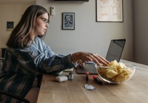 Girl eating chips while working