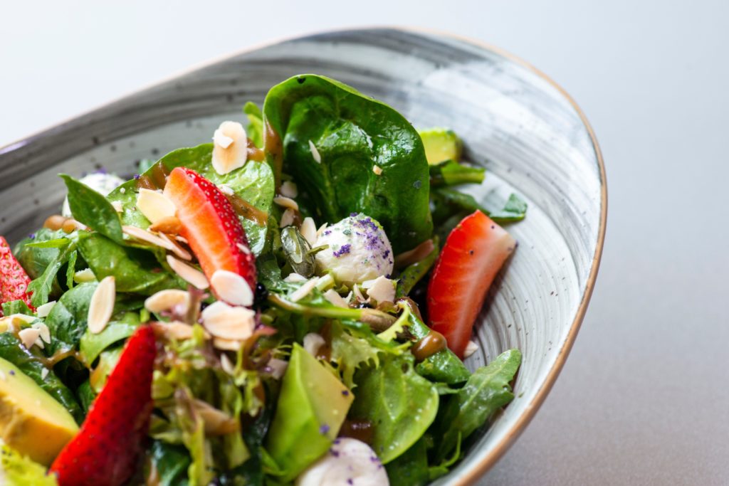 healthy salad with strawberries, almonds and cheese