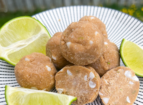 White Chocolate Key Lime Cookie Dough Bites on a plate with limes