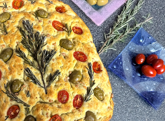 Rosemary Garlic Focaccia with decorated with fresh rosemary, green olives and tomatoes