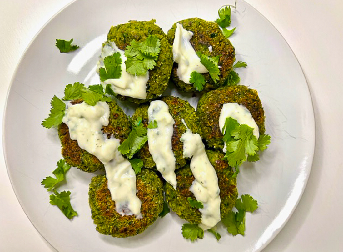 High-fibre detox falafels on a plate drizzled with tatziki