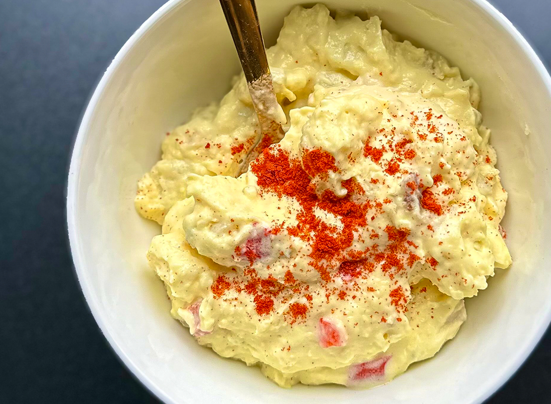 Creamy potato salad in a white bowl