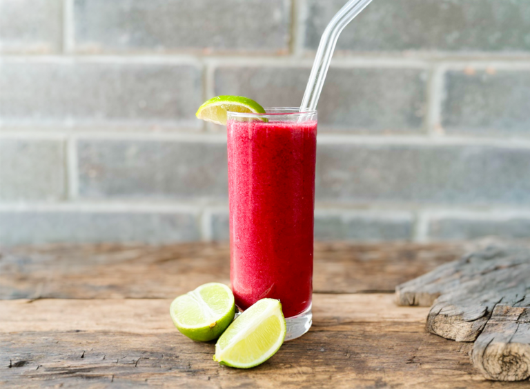 Frozen Immuno Berry Paloma in a tall glass with lime