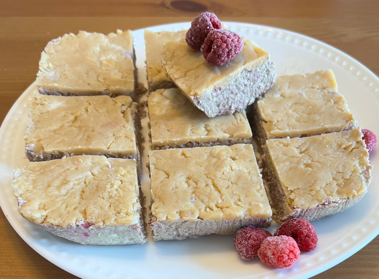Chilled raspberry coconut squares on a white plate