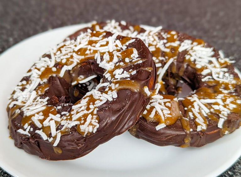 Chocolate-covered apple donuts with caramel magnesium liposomal glaze and shredded coconut topping