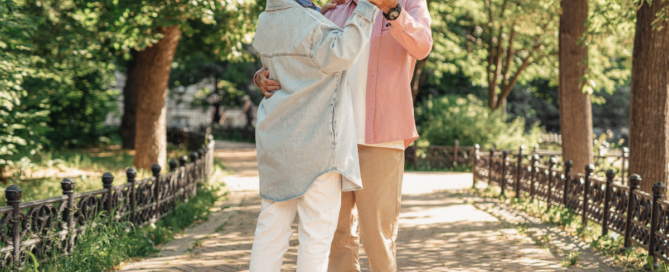 Elderly couple happily dancing outdoors