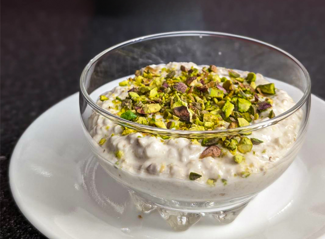 Rose and Lemon Overnight Oats topped with pistachios in a glass bowl