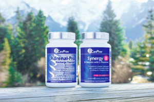CanPrev Andrenal Pro and Synergy B on a wooden ledge with trees in the background