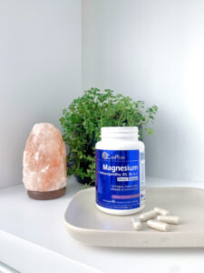 CanPrev Magnesium Stress Release bottle and capsules on a counter next to a salt lamp and a plant