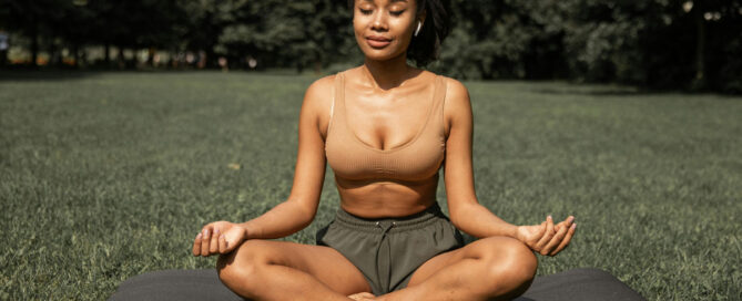 woman meditating in a park