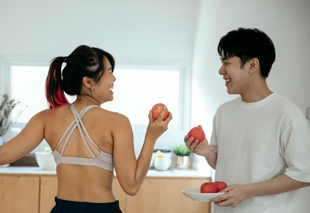 Two people talking in a kitchen