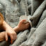 Girl sitting with a mug and a blanket