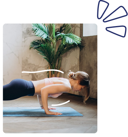 Woman performing a push-up on a blue yoga mat indoors, with a leafy plant in the background.
